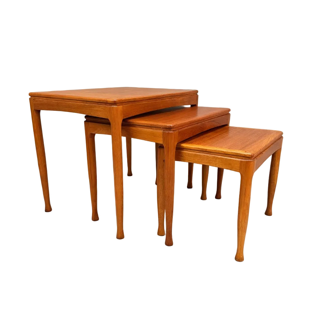 A rare set of Alpa Teak Nesting Tables (Set of 3) in classic Australian mid-century modern style is shown stacked, each with a rectangular top and tapered legs against a plain, light background.