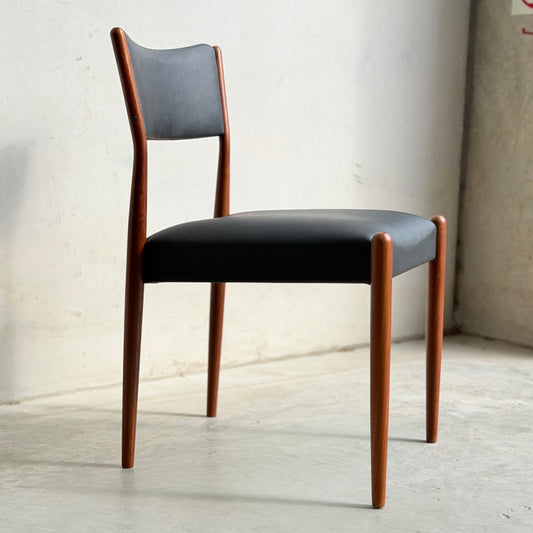The Parker Number 97 Dining Chairs Set of 4 – Licorice Vinyl features a modern design with black cushioned seats and backrests, slim rounded legs, and mid-century inspiration, perfect for minimalist spaces.