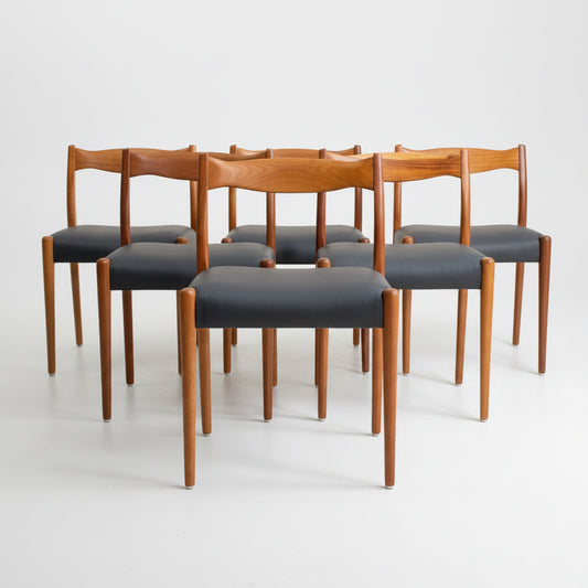 A fully restored set of 6 Fler 64 Dining Chairs in Liquorice Vinyl (Rediscover), arranged in two rows against a plain dark background.