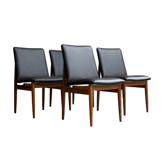 Set of 4 professionally restored Parker 118 Slab Back Chairs, available for pre-order with a 25% non-refundable deposit; featuring black leather seats and backs, and wooden frames.