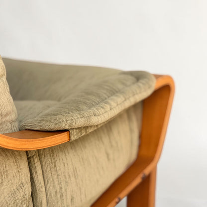 Close-up of a pair of Tessa Monaco Arm Chairs in like-new sage green corduroy, featuring textured fabric cushions and smooth curved wooden frames, evoking mid-century style, set against a plain white background.