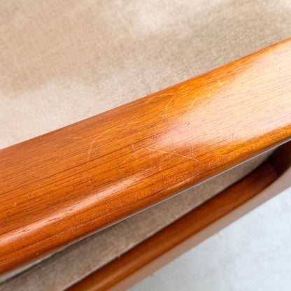 Close-up of a wooden armrest with light scratches and scuffs, attached to cream velvet upholstery. The polished, warm-toned wood reflects the style of the Vintage Mid Century Tessa T21 Swivel Chair (Revive).