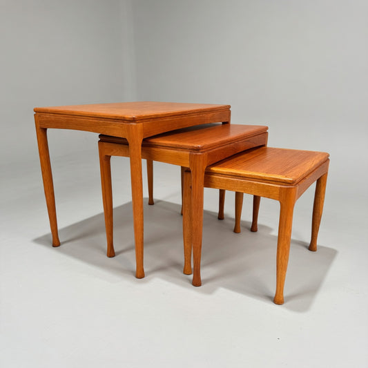 A rare set of Alpa Teak Nesting Tables (Set of 3) in classic Australian mid-century modern style is shown stacked, each with a rectangular top and tapered legs against a plain, light background.