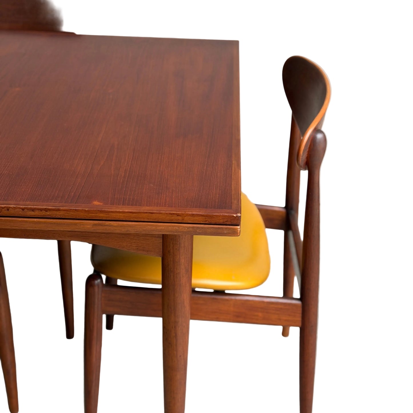 A close-up of the Vintage Mid-Century Parker 109 Nordic Extension Dining Table (Revive), showcasing its sleek rounded edges, set against a white background.