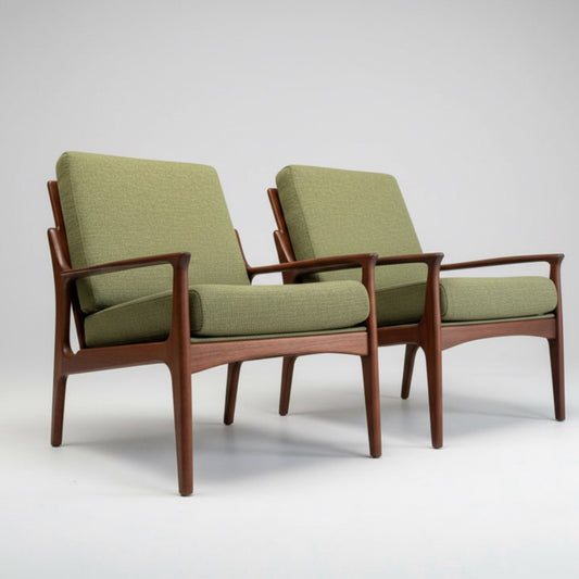 Two Don Rex Armchair - Green Forest (Rediscover) chairs, featuring light green upholstery and wooden frames, sit side by side on a plain light background, showcasing classic mid-century Australian design.