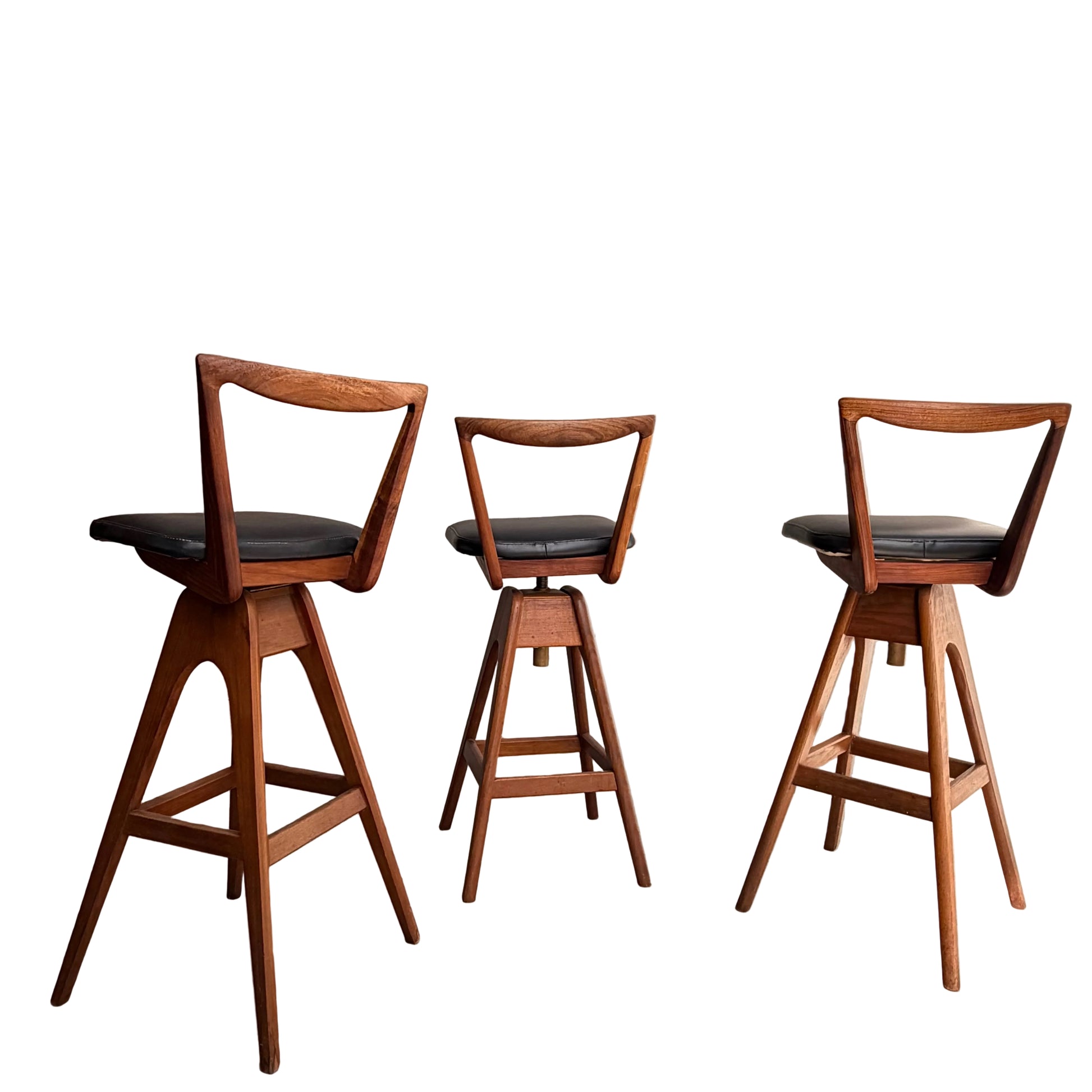 A Set of 3 Vintage THB Bar Stools - COMING SOON features black cushioned seats, mid-century modern triangular open-backs, and angled legs arranged in a row against a white background.