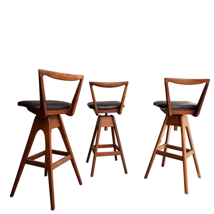 A Set of 3 Vintage THB Bar Stools - COMING SOON features black cushioned seats, mid-century modern triangular open-backs, and angled legs arranged in a row against a white background.