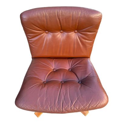A rare set of 4 vintage Joe Rufenacht lounge chairs in brown Howe leather, featuring button tufting, visible creases and slight wear, Scandinavian design, and wooden bases. Photographed from above on a white background.