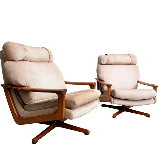 Two Vintage Mid Century Tessa T21 Swivel Chairs (Revive) with cream velvet upholstery and wooden frames sit side by side on a gray concrete floor, each featuring a swivel base and cushioned headrest, embodying timeless mid-century elegance.