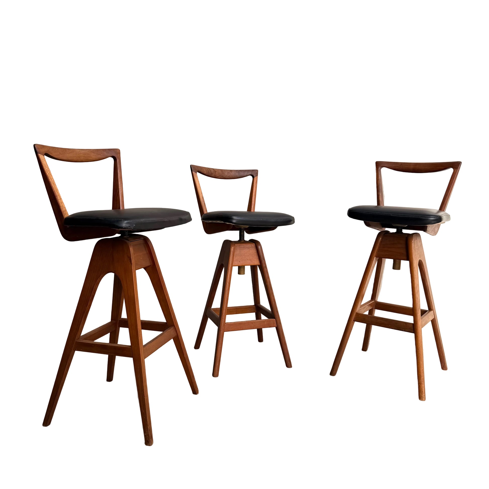 Set of 3 Vintage THB Bar Stools - COMING SOON: These mid-century modern stools feature dark upholstered seats, angled legs, and triangular open backrests, arranged on a white background with a clean, minimalist design.