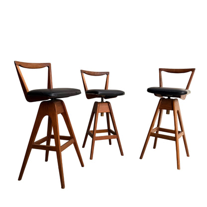 Set of 3 Vintage THB Bar Stools - COMING SOON: These mid-century modern stools feature dark upholstered seats, angled legs, and triangular open backrests, arranged on a white background with a clean, minimalist design.