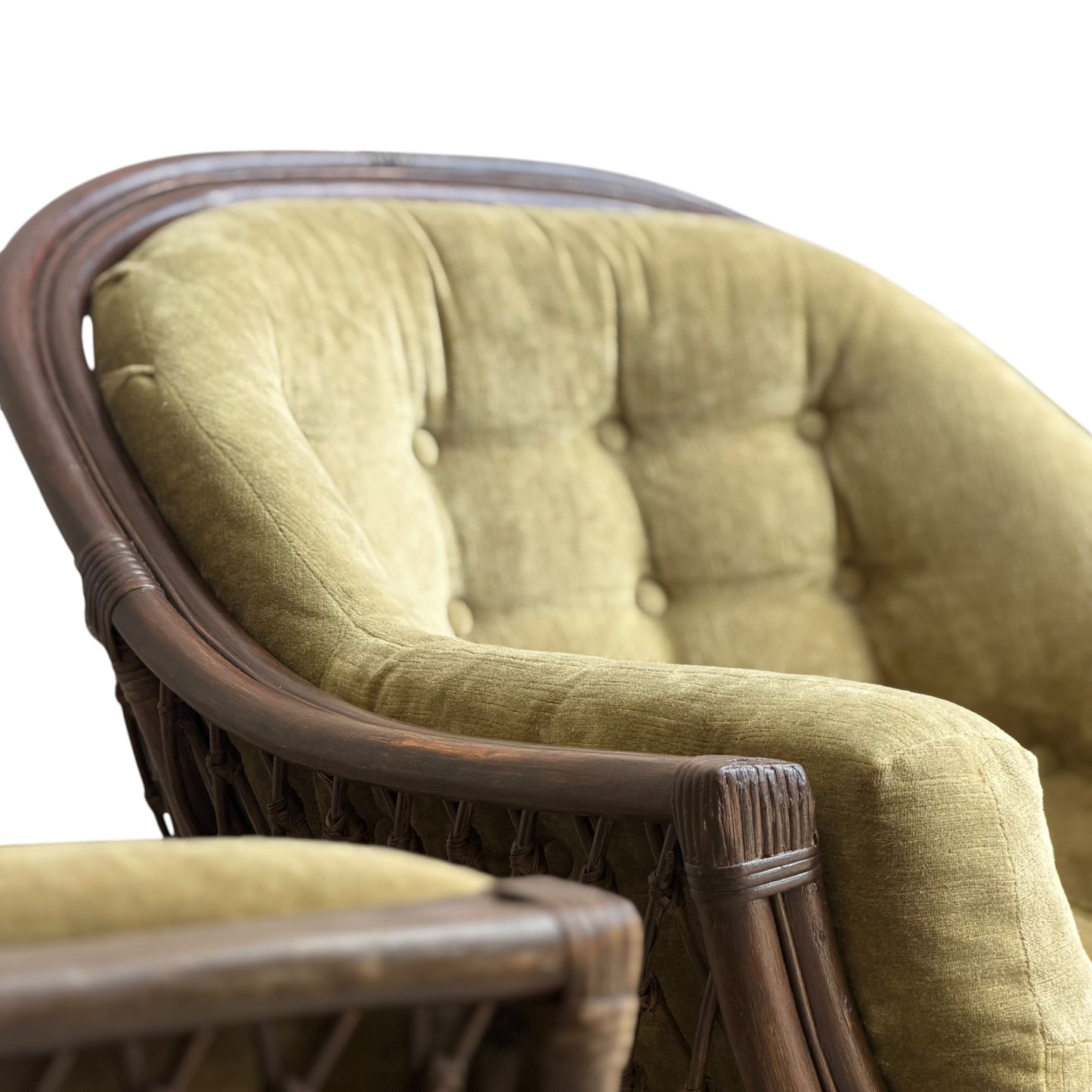 Close-up of the Vintage Adrian Pearsall Style 1970s Rattan Designer Barrel Chair in olive green velvet, highlighting its curved rattan frame and button-tufted backrest with armrest details against a white background.