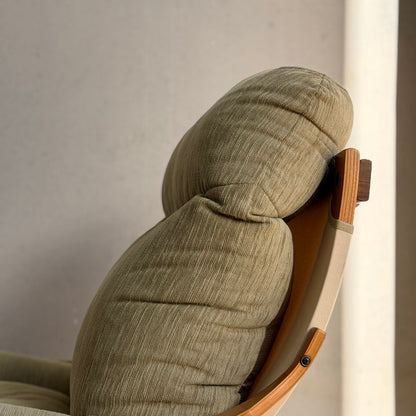 Close-up of a Pair of Tessa Monaco Arm Chairs in sage green corduroy—like new (Revive)—featuring cushioned seats, rounded headrests, and light wooden armrests, showcasing mid-century style against a neutral background.