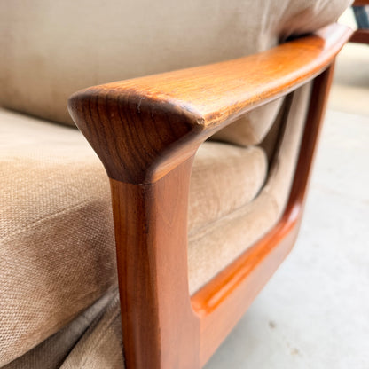 Close-up of the wooden armrest on a Vintage Mid Century Tessa T21 Swivel Chair (Revive), showcasing its smooth, curved design and rich wood grain details against a cream velvet cushion—a sophisticated mid-century accent.