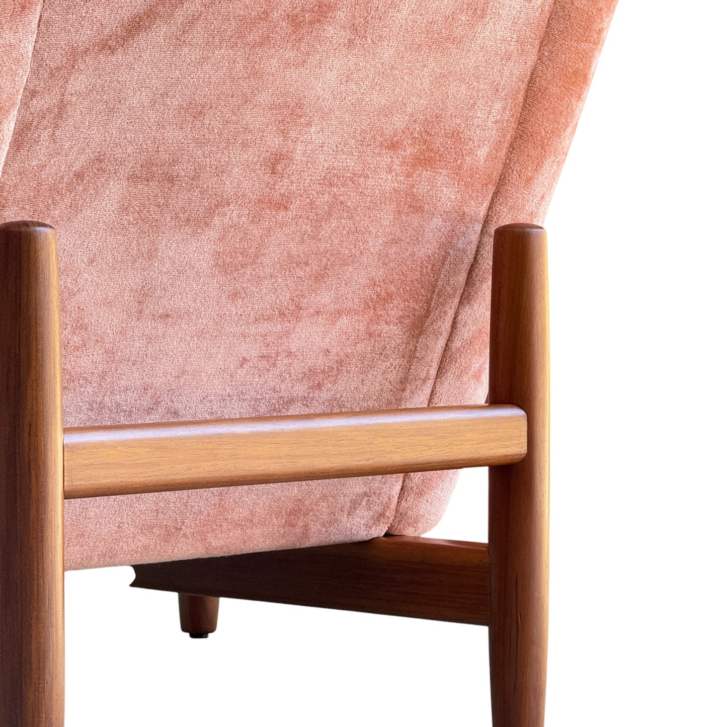 Close-up of a Mid-Century High-Back/Wingback Armchair in dusty pink velvet with Blackwood frames, echoing retro design with its soft, luxurious upholstery and elegant silhouette. Priced individually.