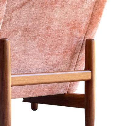 Close-up of a Mid-Century High-Back/Wingback Armchair in dusty pink velvet with Blackwood frames, echoing retro design with its soft, luxurious upholstery and elegant silhouette. Priced individually.