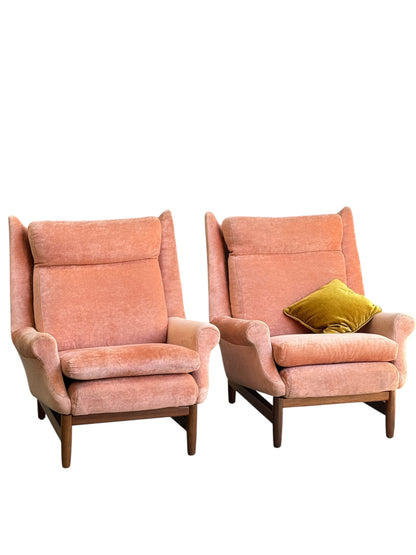 Two Mid-Century High-Back Armchairs in dusty pink velvet with Blackwood frames sit side by side, one styled with a mustard yellow velvet pillow, all set against a white background. Priced individually (Rediscover).