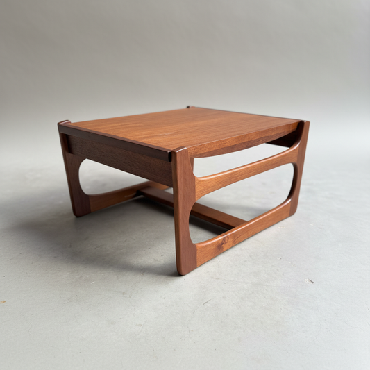 The Ultra Rare Gerald Easden Coffee Table in Blackwood features a sleigh leg base and is inspired by Australian vintage style, with clean lines, a square top, and curved cut-out sides—all set on a light gray background.