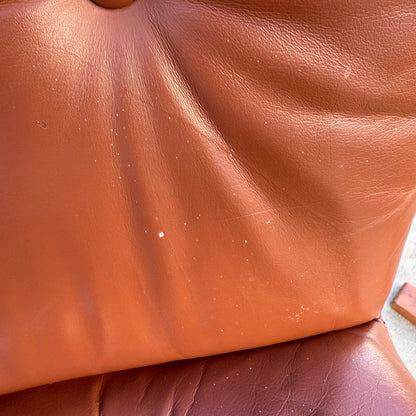 Close-up of a Rare Set of 4 Vintage Joe Rufenacht Lounge Chairs in Howe Leather, featuring brown, slightly worn leather with small white spots and creases on the seat and backrest, reflecting a Scandinavian-inspired design.