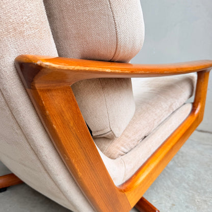 Close-up of the Vintage Mid Century Tessa T21 Swivel Chair (Revive), featuring light beige upholstery and smooth, polished wooden armrests and frame, inspired by mid-century design, set against a neutral background.