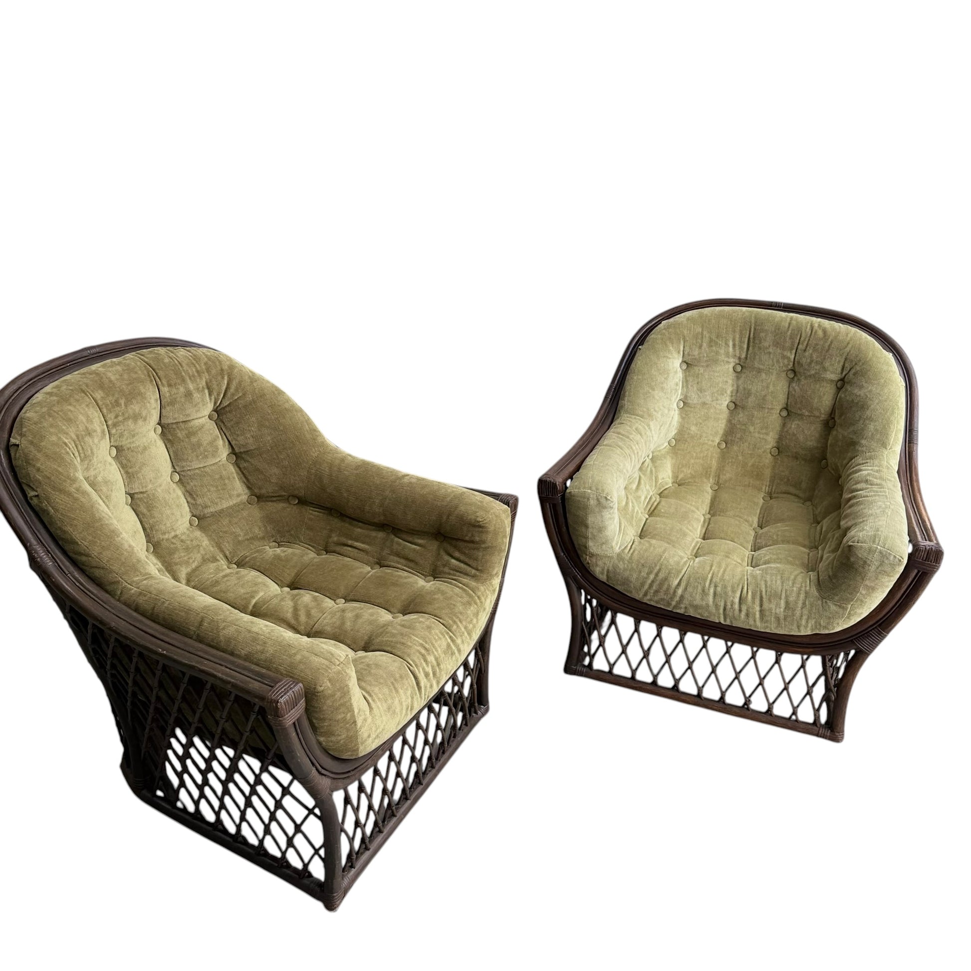 A pair of vintage Adrian Pearsall style 1970s rattan designer barrel chairs with olive green velvet cushions, brown wicker frames, and tufted backs are arranged at an angle on a white background.