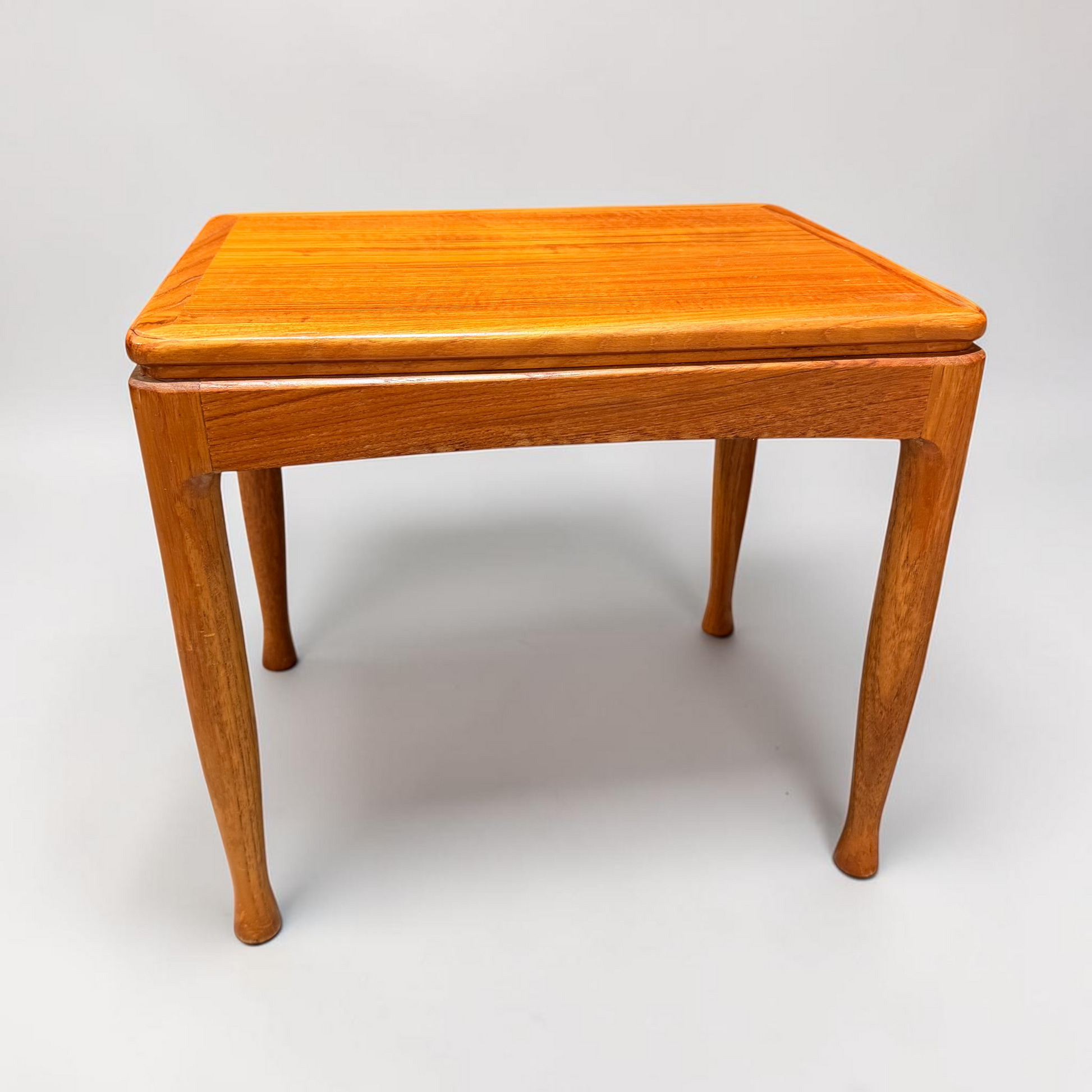 A rare set of Alpa Teak Nesting Tables (set of 3), featuring Australian mid-century modern design with a polished light brown finish and minimalist style, shown against a plain white background.