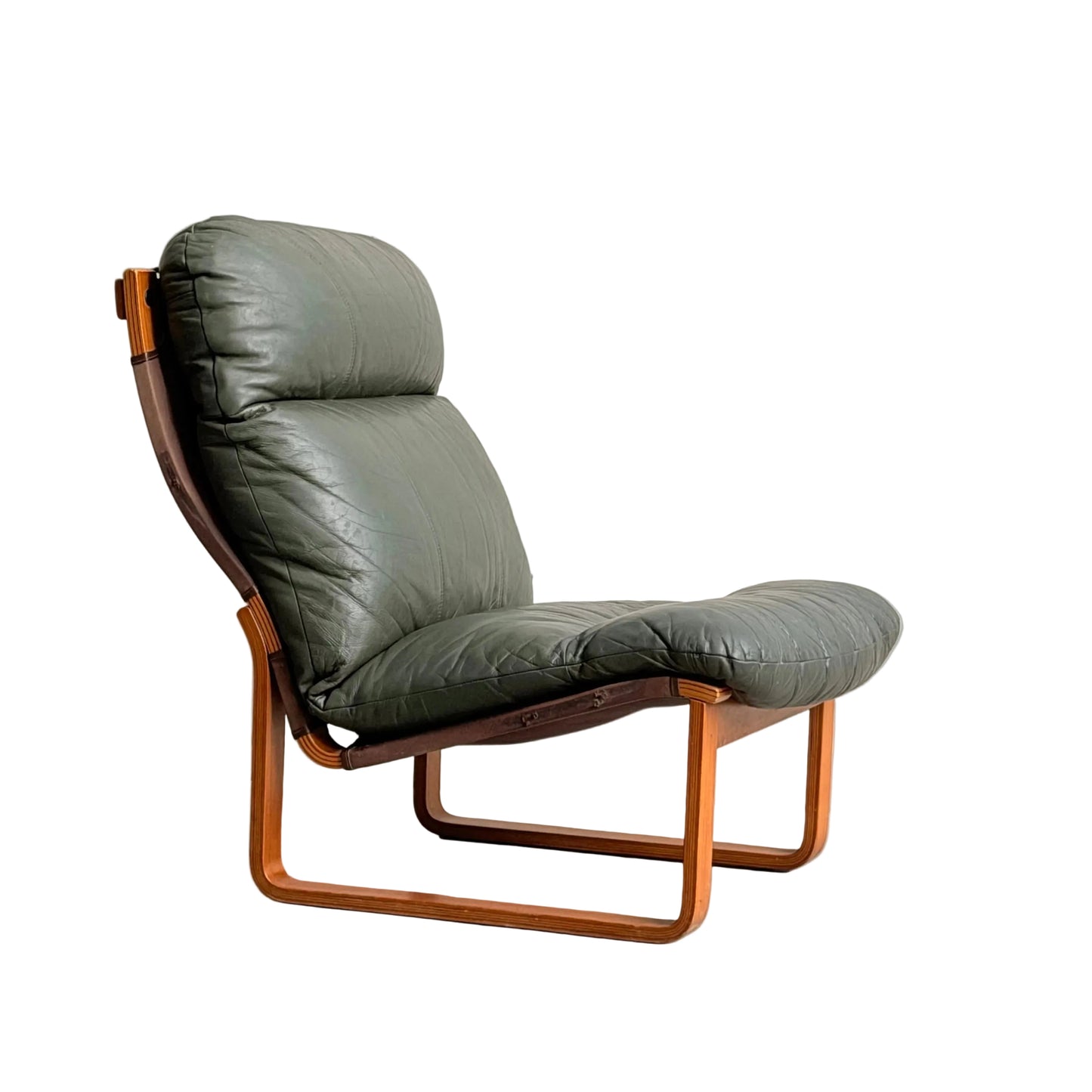 The Tessa Vintage Single No Arm Monaco Armchair in Forest Green (Revive) features a modern, mid-century inspired design with leather accents and a wooden frame, shown against a plain gray background.