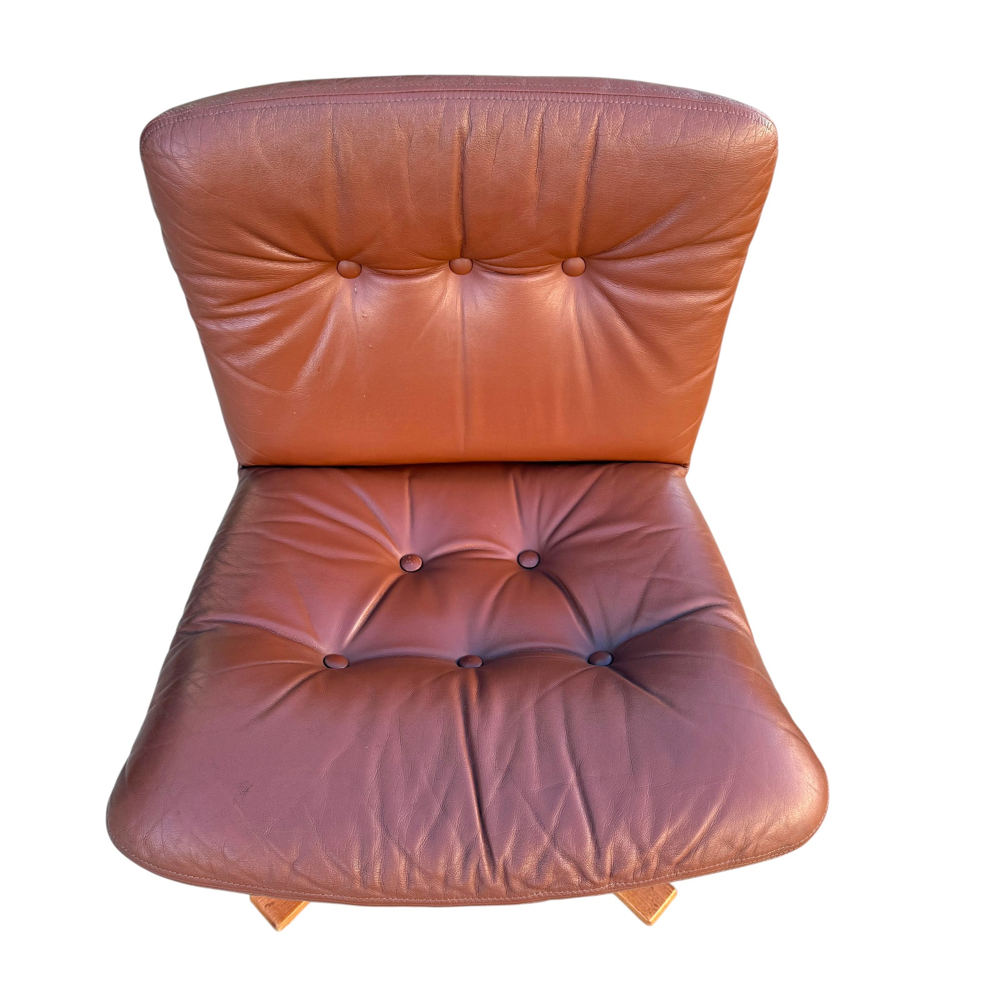 A rare set of 4 vintage Joe Rufenacht lounge chairs in Howe leather, each featuring a brown tufted design with visible creases and wear, photographed from above on a white background—classic Scandinavian style.