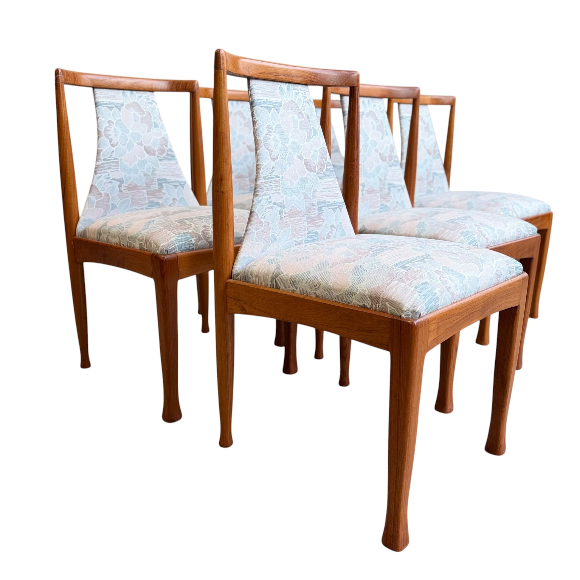 Set of six Vintage CRO Teak Dining Chairs (Revive) with light blue and pastel floral upholstered seats and backs, arranged in two rows on a white background.