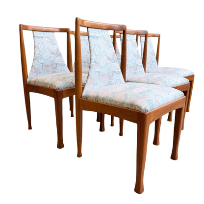 Set of six Vintage CRO Teak Dining Chairs (Revive) with light blue and pastel floral upholstered seats and backs, arranged in two rows on a white background.