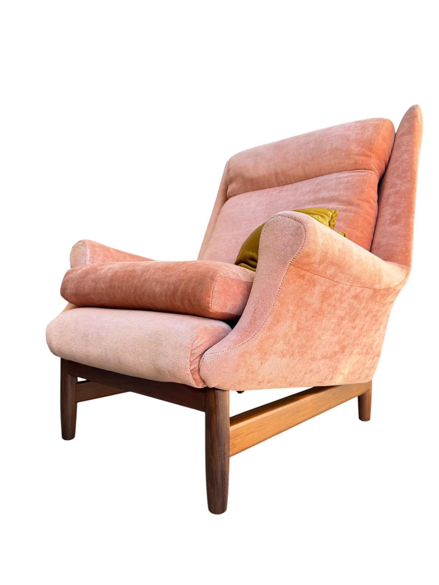 A Mid-Century High-Back Wingback Armchair in dusty pink velvet with Blackwood frames, featuring soft upholstery and a green cushion, is shown against a white background. Priced individually.