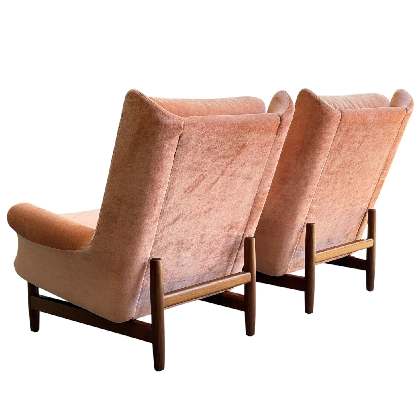 Two Mid-Century High-Back Wingback Armchairs in dusty pink velvet with Blackwood frames are positioned side by side, facing away from the viewer, against a white background. Each armchair is priced individually (Rediscover).