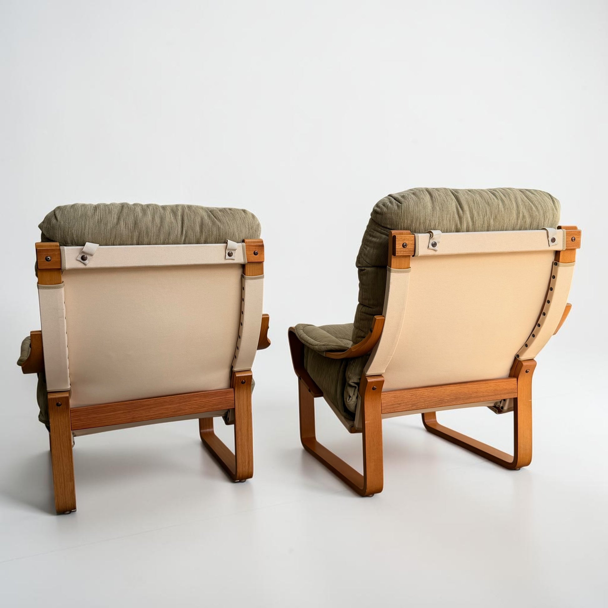 A pair of Tessa Monaco Arm Chairs in like new condition, upholstered in sage green corduroy, are placed side by side facing away from the camera against a plain white background.