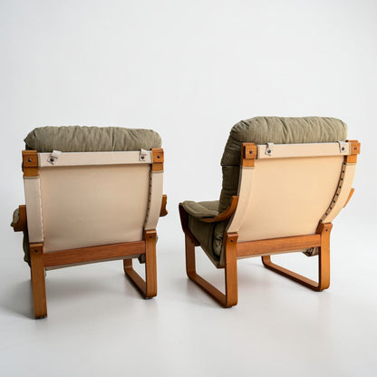 A pair of Tessa Monaco Arm Chairs in like new condition, upholstered in sage green corduroy, are placed side by side facing away from the camera against a plain white background.