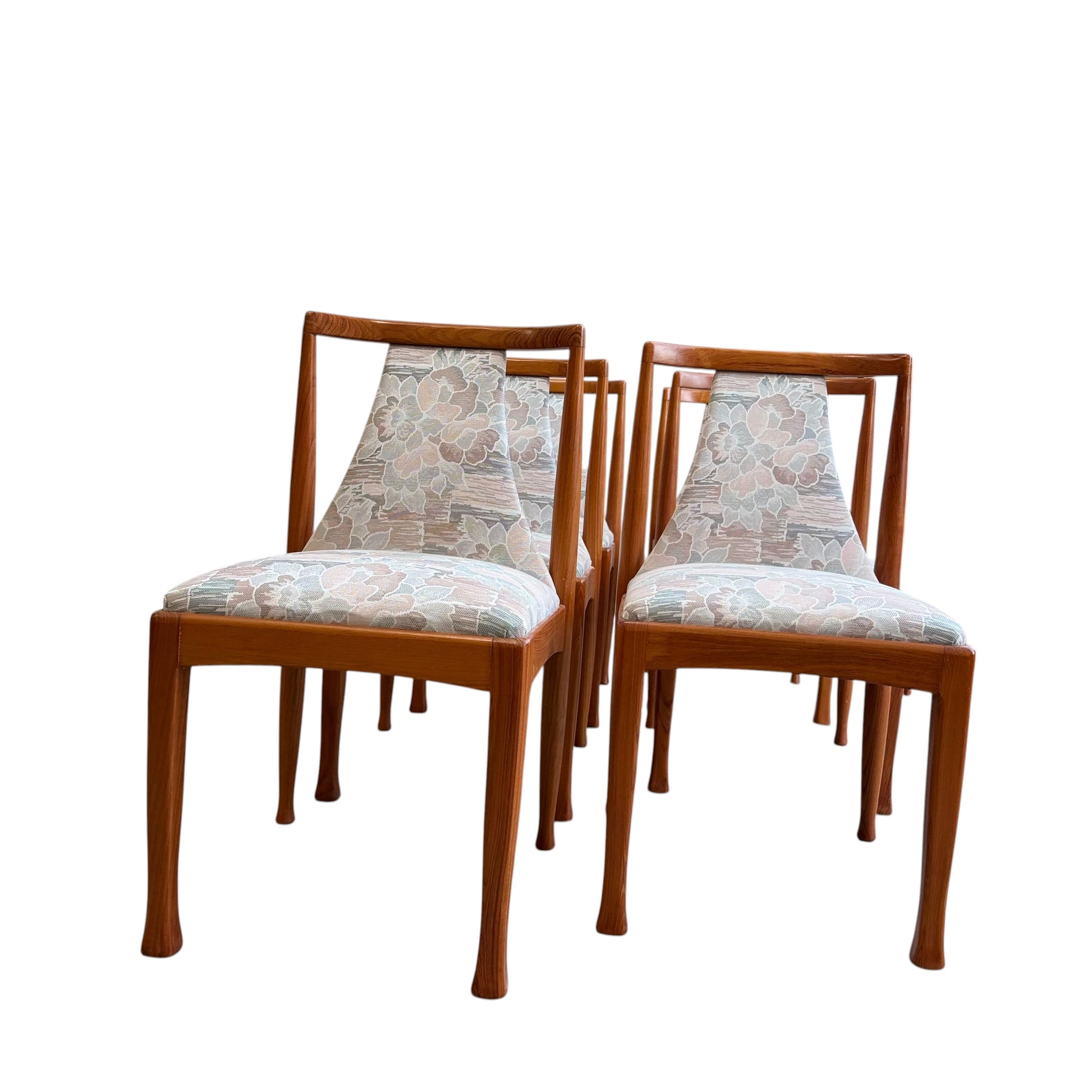 A set of six Vintage CRO Teak Dining Chairs – Set of 6 (Revive) with upholstered seats and floral-patterned backs, arranged in two rows against a white background.