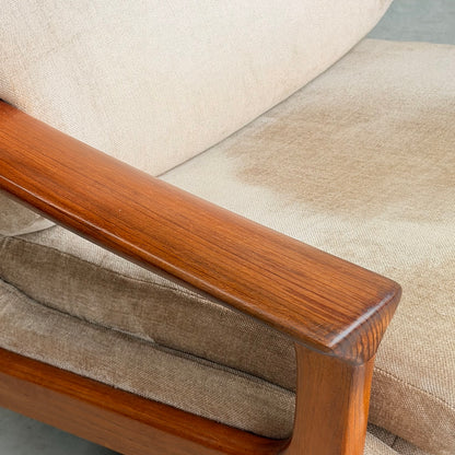Close-up of a wooden armrest on the Vintage Mid Century Tessa T21 Swivel Chair (Revive), highlighting a large water stain on the cream velvet cushion—a common feature in vintage pieces.