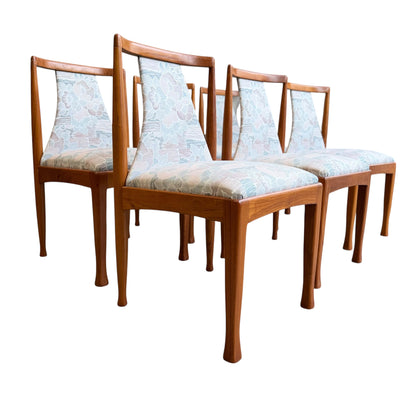 Six Vintage CRO Teak Dining Chairs (Revive) with light floral upholstered seats and backs, featuring clean lines reminiscent of classic mid-century modern Australian design, arranged in staggered rows on a white background.