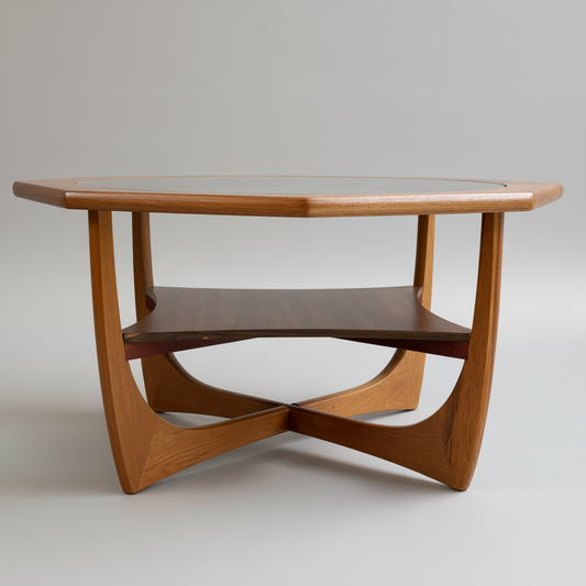 A mid-century Octagonal Coffee Table by Kalmar Furniture, featuring hardwood construction, smoked glass top, sculptural curved legs, and a built-in magazine rack, is shown against a neutral background.