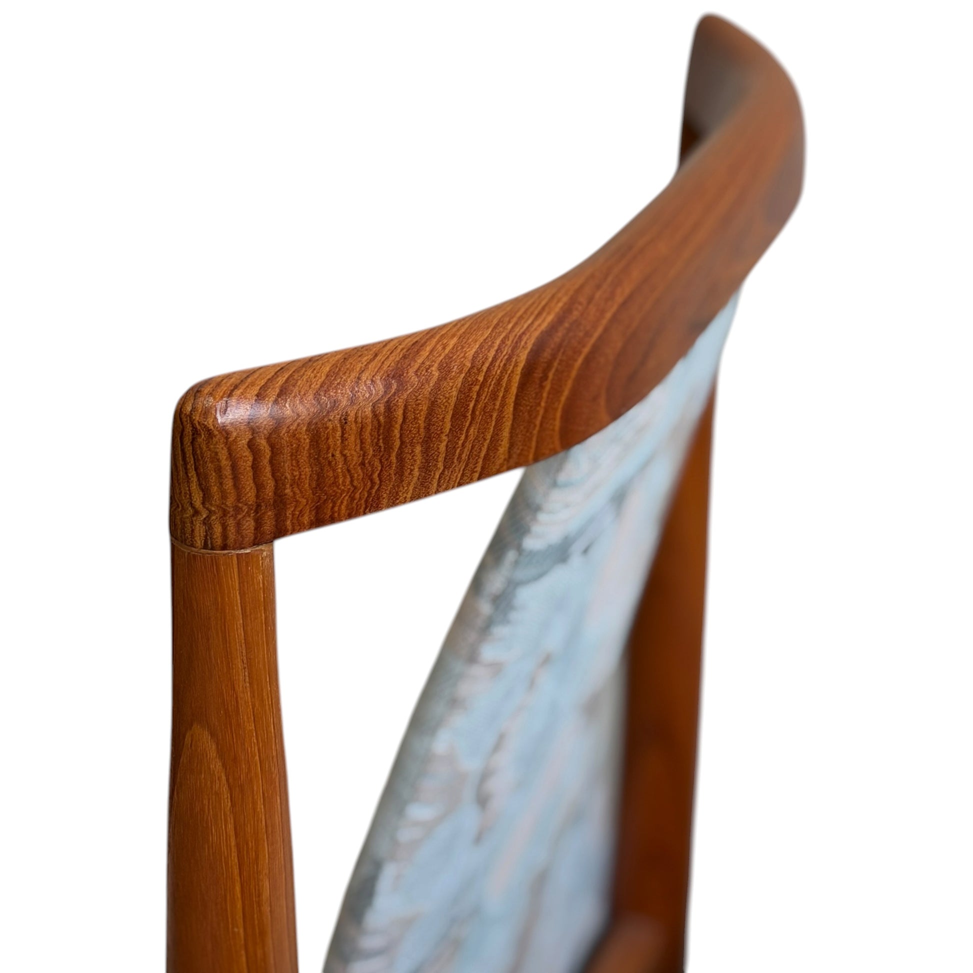Close-up of the upper backrest on a Vintage CRO Teak Dining Chair from the Revive set of 6, showcasing smooth curves, visible teak wood grain, and a light-patterned upholstered panel inspired by mid-century modern Australian design.
