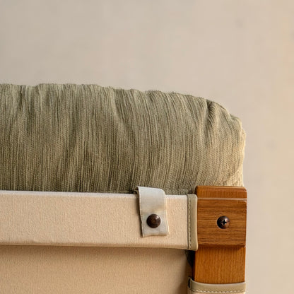 Close-up of a Tessa Monaco Arm Chair from the Pair of Tessa Monaco Arm Chairs - Sage Green Corduroy Like New (Revive), showing its sage green corduroy cushion and materials, with a neutral background emphasizing its mid-century design.