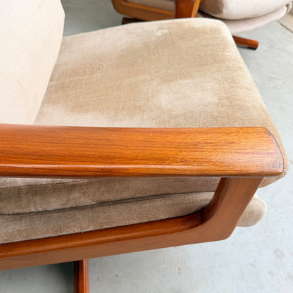 Close-up of a Vintage Mid Century Tessa T21 Swivel Chair (Revive) with light brown upholstery and wooden armrest, highlighting its mid-century design. A similar chair appears partially in the background.