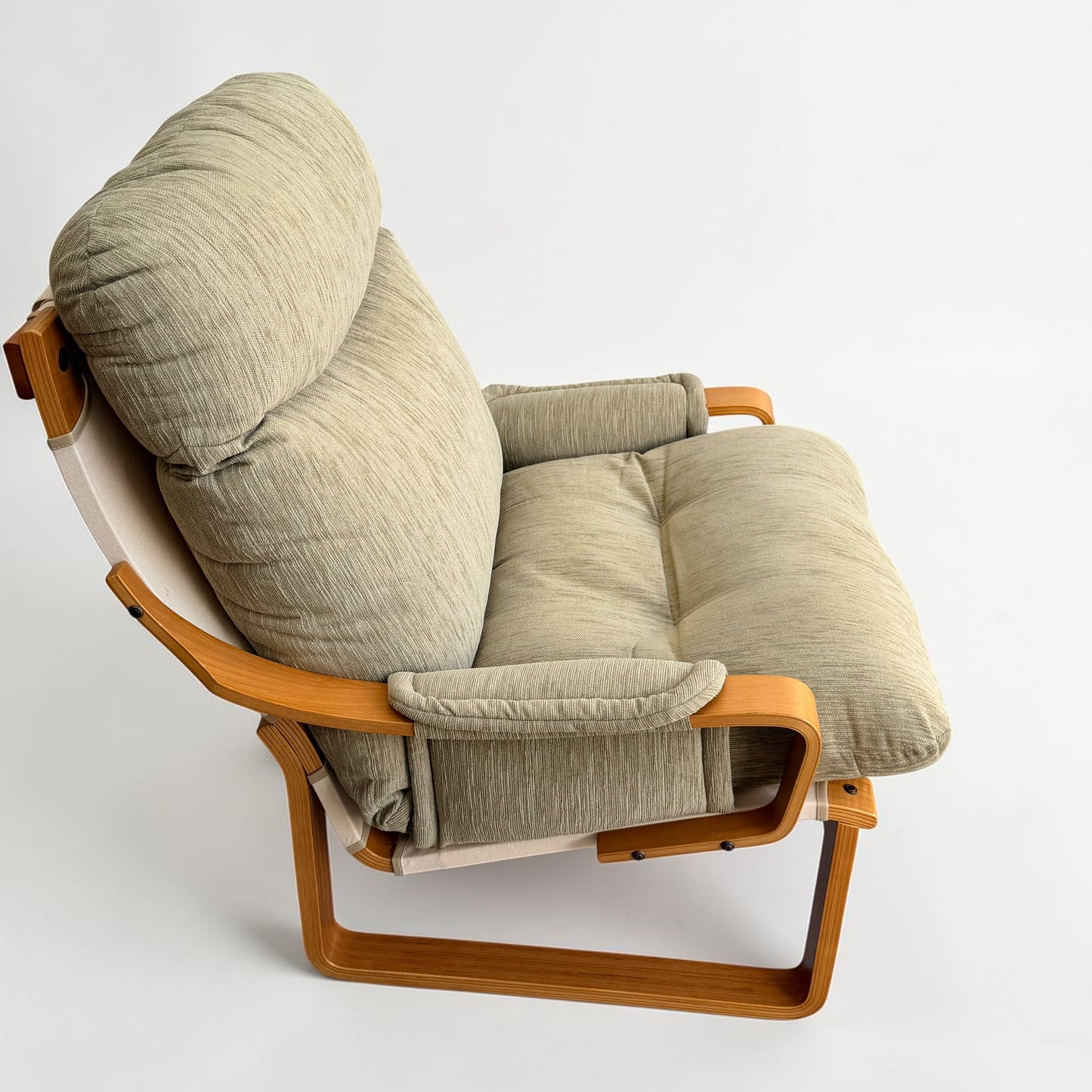 A pair of Tessa Monaco Arm Chairs in sage green corduroy, like new, featuring plush cushions and wooden armrests with a bentwood frame. Their modern design is comfortable and inviting against a plain white background.
