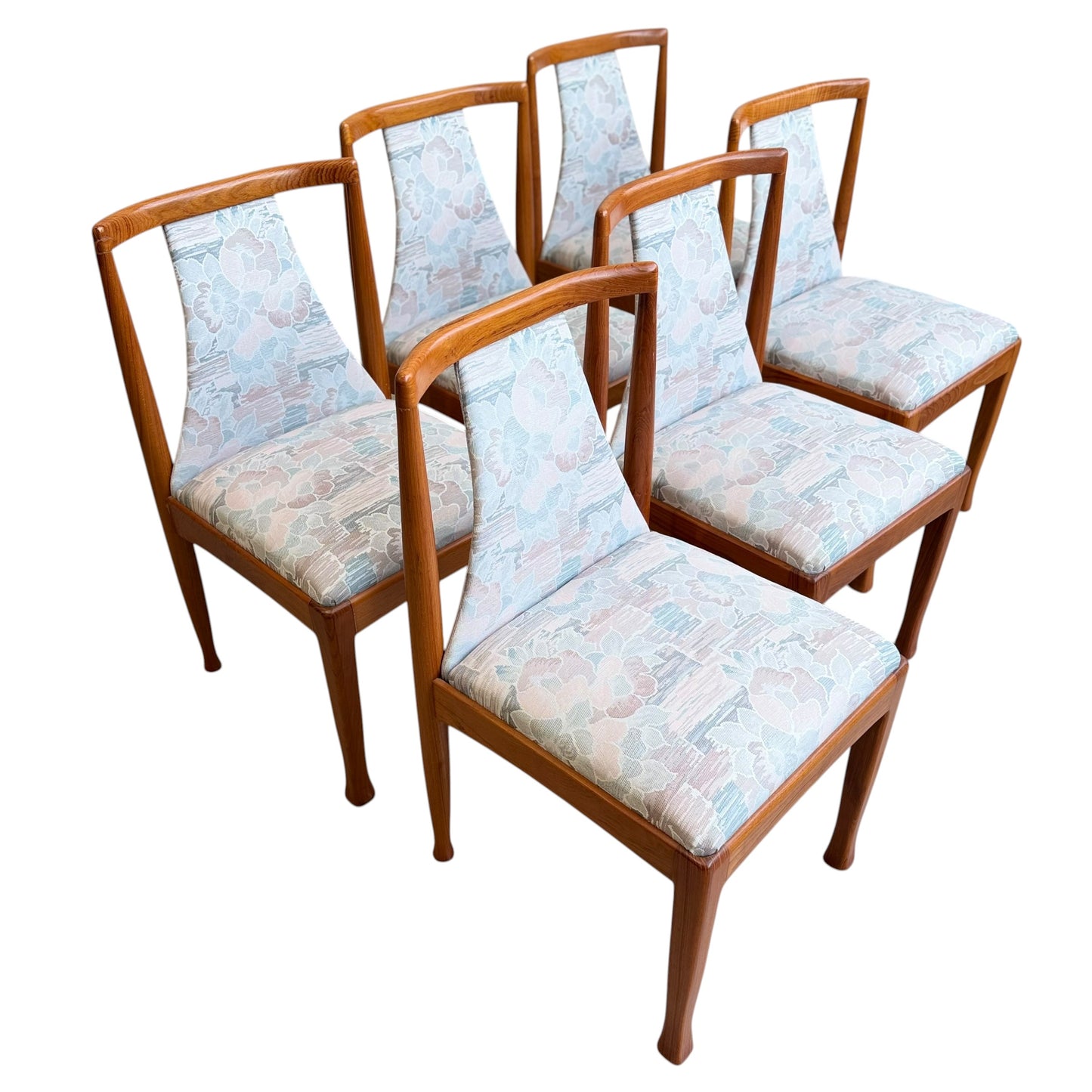 A set of six Vintage CRO Teak Dining Chairs (Revive) is arranged in two rows of three, featuring mid-century modern design with curved backs and pastel-patterned upholstered seats and backrests against a white background.