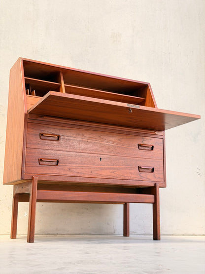 The Mid Century Modern Danish Arne Wahl Iversen Model 68 Teak Secretary Desk by Vinde Møbelfabrik features an open top compartment, fold-down writing surface with interior storage, and two drawers on four legs against a light wall.