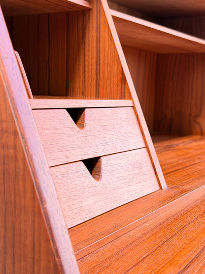 Close-up of the Mid Century Modern Danish Arne Wahl Iversen Model 68 Teak Secretary Desk by Vinde Møbelfabrik, featuring two small drawers with triangular cut-out handles and open shelves above that showcase its elegant wood grain.