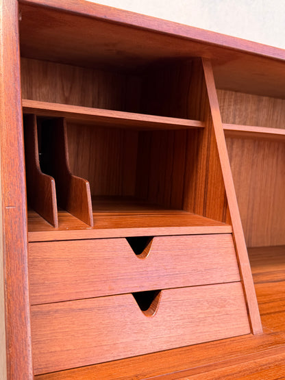 Close-up of the Mid Century Modern Danish Arne Wahl Iversen Model 68 Teak Secretary Desk by Vinde Møbelfabrik, featuring two drawers with cut-out handles, vertical paper dividers, and open shelves above for organization.