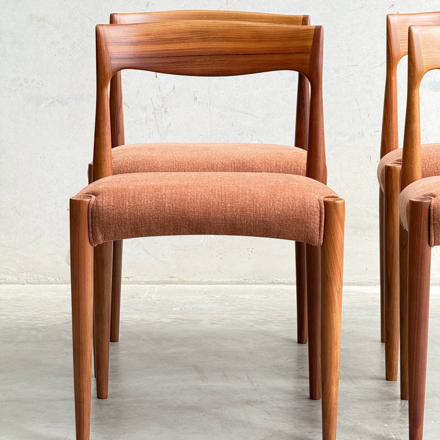 A fully restored THB 'Milan' Dining Chair from a set of 4 (Rediscover) with a curved backrest and light brown upholstered seat sits on a light gray floor, alongside part of another matching chair.