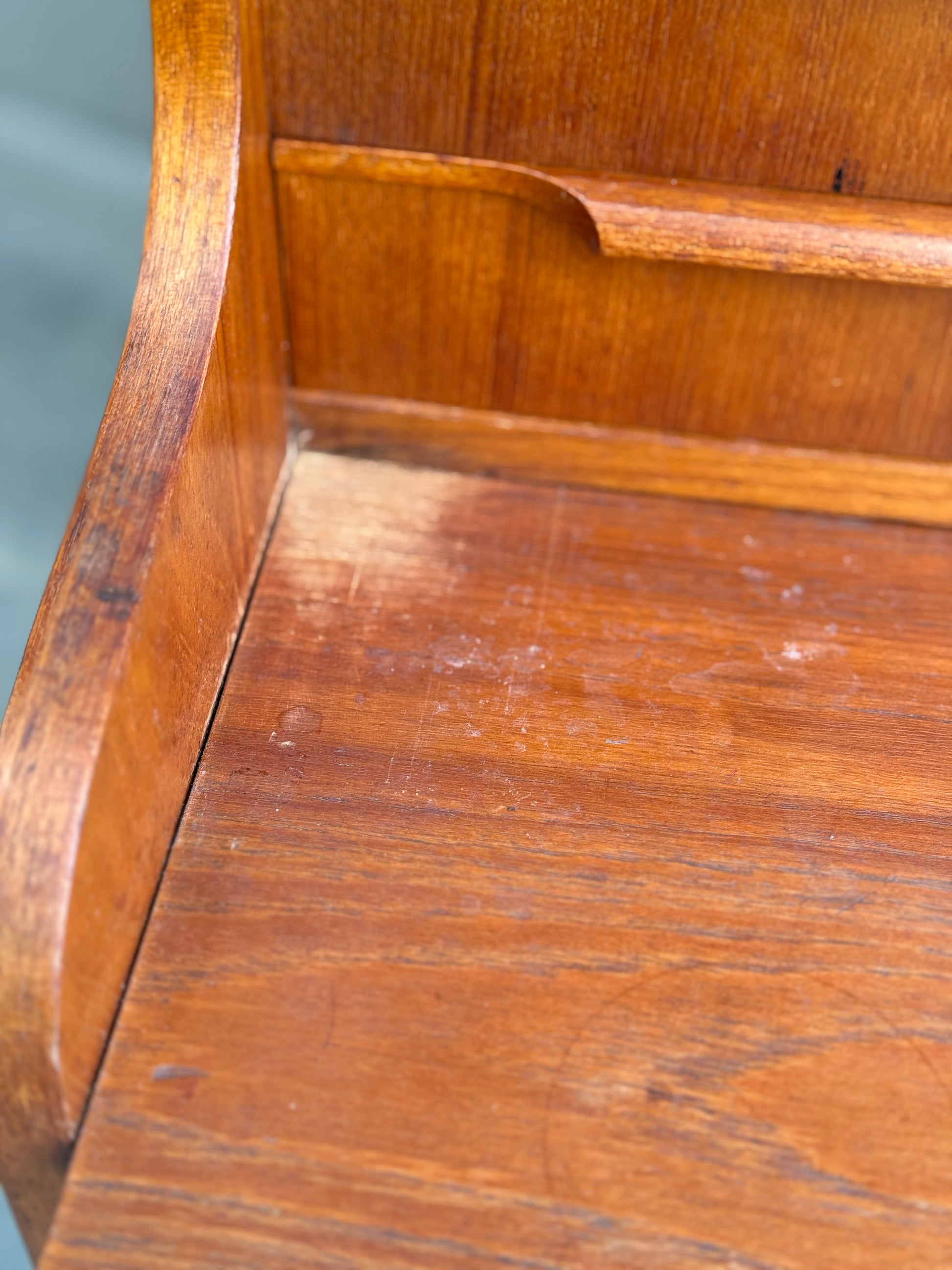 A close-up of the Danish Teak Bureau Bookcase Secretary Desk by Erik Petersen for EP Møbler, showing noticeable discoloration and wear with faded, scratched wood grain typical of mid-century Scandinavian design.