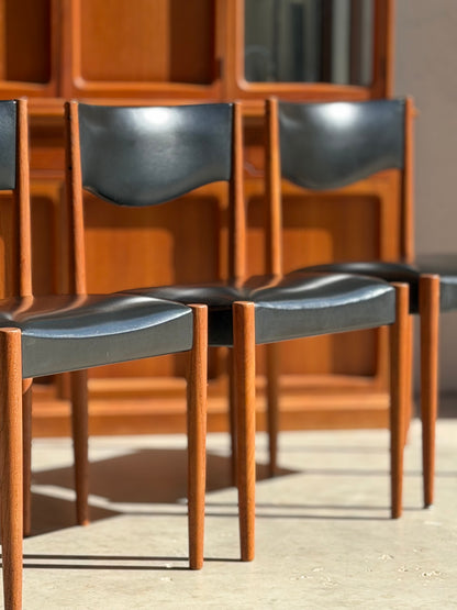Close-up of Parker Number 62 dining chair highlighting the minimalist mid-century modern backrest and warm teak tones