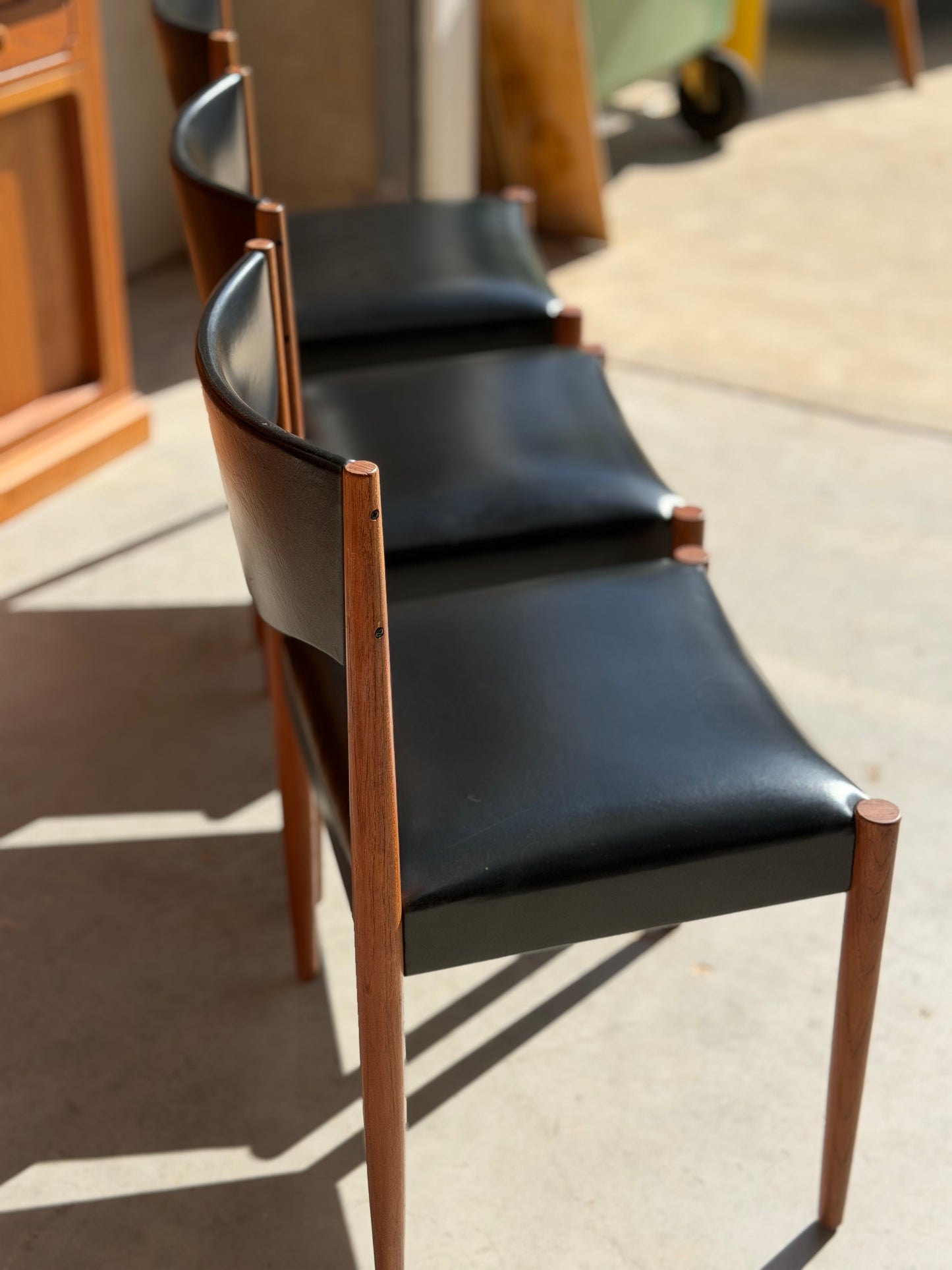 Detail of original black vinyl upholstery on restored Parker Number 62 mid-century modern dining chair